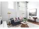 Comfortable living room with a leather sofa, chic decor, and lots of natural light at 964 Dekalb Ne Ave # 112, Atlanta, GA 30307