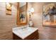 Close up of a half bathroom featuring marble countertops, unique artwork, and a decorative mirror at 1014 Seaboard Nw Ave, Atlanta, GA 30318