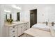 Bright bathroom boasts double sinks, large mirror, and neutral stone countertop at 1014 Seaboard Nw Ave, Atlanta, GA 30318