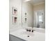 Well-lit bathroom features a white vanity with bronze fixtures and decorative wall art at 1014 Seaboard Nw Ave, Atlanta, GA 30318