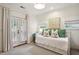 Cozy bedroom with a daybed, complemented by green pillows and a French door at 1014 Seaboard Nw Ave, Atlanta, GA 30318
