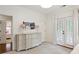 Bright bedroom featuring a dresser, complemented by French doors leading to the outside at 1014 Seaboard Nw Ave, Atlanta, GA 30318
