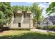 Side exterior of the house with attached two-car garage, and a lovely garden area with a small back porch at 1014 Seaboard Nw Ave, Atlanta, GA 30318