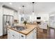 Open concept kitchen features a gas stovetop on the island, flowing into a living area with a fireplace at 1014 Seaboard Nw Ave, Atlanta, GA 30318