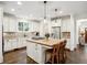 Bright kitchen features white cabinets, stainless appliances, wood island with seating, and pendant lighting at 1014 Seaboard Nw Ave, Atlanta, GA 30318