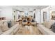 Open concept living room with access to the kitchen with chairs and sofas surrounding a coffee table at 1014 Seaboard Nw Ave, Atlanta, GA 30318