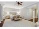 Spacious main bedroom with large rug, sitting area, bedside tables and lamps, and large windows at 1014 Seaboard Nw Ave, Atlanta, GA 30318