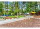 Inviting outdoor area with colorful chairs, green turf, mature trees, and gravel pathways, perfect for relaxing or socializing at 1014 Seaboard Nw Ave, Atlanta, GA 30318