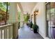 Inviting porch with dark wood floors, sconce lighting, and neutral exterior paint at 1014 Seaboard Nw Ave, Atlanta, GA 30318
