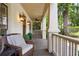 Relaxing front porch with classic columns, ceiling fan and stylish outdoor furnishings at 1014 Seaboard Nw Ave, Atlanta, GA 30318