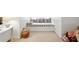 Charming reading nook with a cushioned bench, complemented by a basket and natural light at 1014 Seaboard Nw Ave, Atlanta, GA 30318