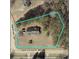 An aerial view of the property shows the house, driveway, surrounding trees, and borders, highlighting the expansive outdoor space at 102 Aristocratic Way, Locust Grove, GA 30248