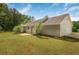 Large backyard with lush green grass, mature trees, and a charming patio area, great for outdoor living at 102 Aristocratic Way, Locust Grove, GA 30248