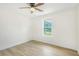Minimalist bedroom with ceiling fan, wood-look floors and large window at 102 Aristocratic Way, Locust Grove, GA 30248