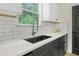 Modern kitchen counter with white subway tile backsplash and stainless steel faucet at 102 Aristocratic Way, Locust Grove, GA 30248