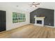 Bright living room with fireplace, large window, and hardwood floors at 102 Aristocratic Way, Locust Grove, GA 30248
