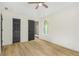 Light-filled bedroom with wood-look floors, ceiling fan, and ensuite bathroom view at 102 Aristocratic Way, Locust Grove, GA 30248