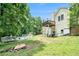 Backyard showcasing a swimming pool, deck, and home exterior set against a backdrop of mature trees at 1211 Fly Rod Ln, Loganville, GA 30052