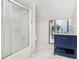 Bathroom featuring vanity with a frosted glass shower and a vanity with navy blue cabinets at 1211 Fly Rod Ln, Loganville, GA 30052
