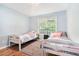 Cozy bedroom featuring two twin beds and a large window at 1211 Fly Rod Ln, Loganville, GA 30052