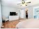 Bright bedroom with hardwood floors, television, chair, walk-in closet, and ensuite bathroom at 1211 Fly Rod Ln, Loganville, GA 30052