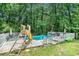 Backyard swimming pool featuring a slide, lounge chairs, and deck for relaxing in the sun at 1211 Fly Rod Ln, Loganville, GA 30052