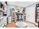 Large walk-in closet with custom shelves, hanging racks, storage and sitting area at 1211 Fly Rod Ln, Loganville, GA 30052