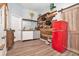 Entertaining wet bar with wine rack, red retro refrigerator, and custom reclaimed wood accent wall at 1211 Fly Rod Ln, Loganville, GA 30052