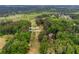 Enjoy this aerial view of the Collins Hill Golf Course, surrounded by lush trees and a few community homes at 2228 Walker Dr, Lawrenceville, GA 30043