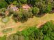 Aerial view of the property backing up to a pristine golf course surrounded by lush trees at 2228 Walker Dr, Lawrenceville, GA 30043