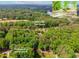 Aerial view of a property near Collins Hill Golf Course with lush greenery and mature trees at 2228 Walker Dr, Lawrenceville, GA 30043