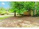 Secluded backyard featuring mature trees and a home with brick and wood facade at 2228 Walker Dr, Lawrenceville, GA 30043