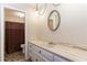 Bathroom with a marble countertop vanity, unique light fixture, and an adjacent toilet at 2228 Walker Dr, Lawrenceville, GA 30043