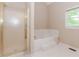 Bathroom featuring a large soaking tub, shower, and tile floors at 2228 Walker Dr, Lawrenceville, GA 30043