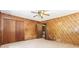 Bedroom featuring wood paneled walls, a ceiling fan, and a view to another room at 2228 Walker Dr, Lawrenceville, GA 30043