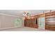 Large bedroom with built in wooden cabinets, book shelves, a fan, and neutral walls and carpet at 2228 Walker Dr, Lawrenceville, GA 30043
