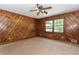 Unique bedroom features natural wood paneling, a ceiling fan, and a view to the outdoors at 2228 Walker Dr, Lawrenceville, GA 30043