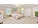 Bright bedroom featuring a large bed, ceiling fan, and lots of natural light at 2228 Walker Dr, Lawrenceville, GA 30043