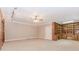 Large bedroom with built in wooden cabinets and book shelves, neutral walls and carpet, and track lighting at 2228 Walker Dr, Lawrenceville, GA 30043