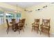 Bright dining room with a chandelier, bay windows, and a full set of wooden furniture at 2228 Walker Dr, Lawrenceville, GA 30043