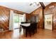Dining room with wood paneled walls, hardwood floors, sliding glass door and table and chairs at 2228 Walker Dr, Lawrenceville, GA 30043