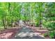 Long private driveway leading to a home surrounded by a canopy of trees and natural landscaping at 2228 Walker Dr, Lawrenceville, GA 30043
