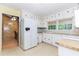 Well-lit kitchen with white appliances and cabinets, and an open view to a breakfast nook at 2228 Walker Dr, Lawrenceville, GA 30043