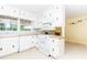 Bright white kitchen featuring white appliances, cabinets, and a view to the backyard at 2228 Walker Dr, Lawrenceville, GA 30043