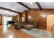 Comfortable living room with wood paneled walls, hardwood floors, and a vaulted ceiling with wooden beams at 2228 Walker Dr, Lawrenceville, GA 30043