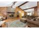 Spacious living room featuring a brick fireplace, wood paneled walls, and hardwood floors with beautiful rug at 2228 Walker Dr, Lawrenceville, GA 30043