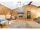 Inviting living room featuring a brick fireplace, wood paneled walls, and hardwood floors with classic décor at 2228 Walker Dr, Lawrenceville, GA 30043