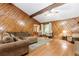 Cozy living room with wood paneled walls, hardwood floors, and a vaulted ceiling with wooden beams at 2228 Walker Dr, Lawrenceville, GA 30043