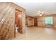 This large living room features wood paneling, updated flooring, and view to the bathroom at 2228 Walker Dr, Lawrenceville, GA 30043