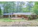 Aerial view of backyard featuring brick house, wood deck, grass, and mature trees at 2279 Parkview Cir, College Park, GA 30337